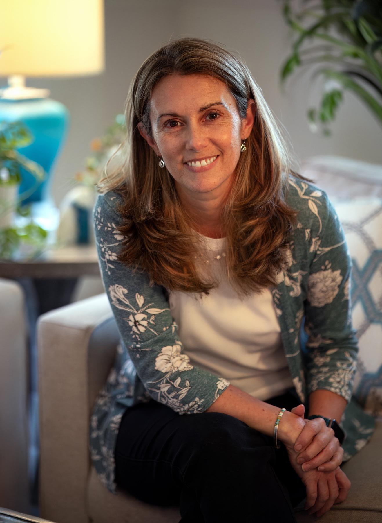 Meg Simmons seated in her therapy office, smiling warmly